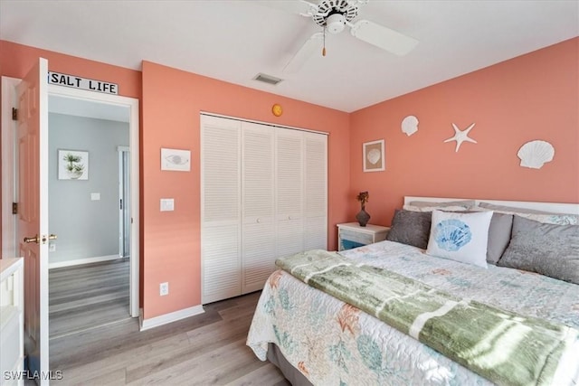 bedroom featuring ceiling fan, a closet, and light hardwood / wood-style flooring