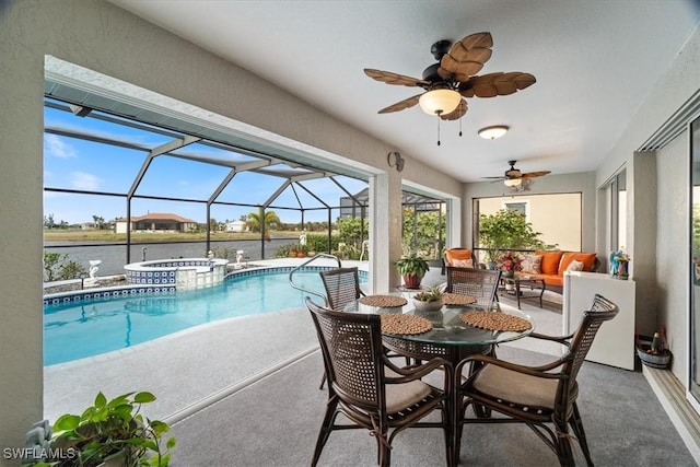 view of pool with an in ground hot tub, a patio, a water view, and glass enclosure