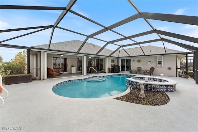 view of pool with glass enclosure, ceiling fan, and a patio