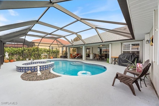 view of pool with glass enclosure, grilling area, and a patio area