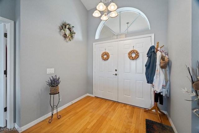 entryway with light wood-type flooring and a chandelier