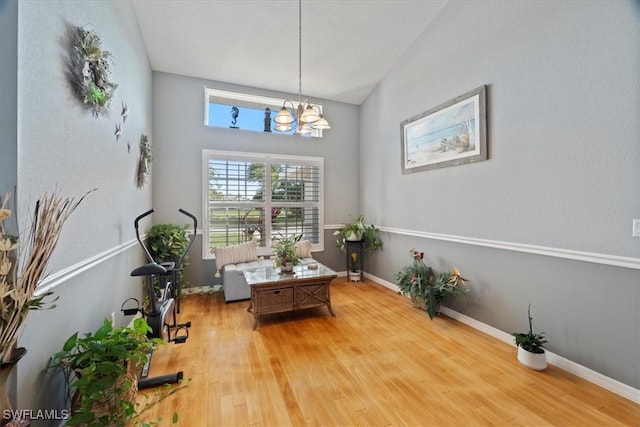 living area with light hardwood / wood-style flooring and a chandelier