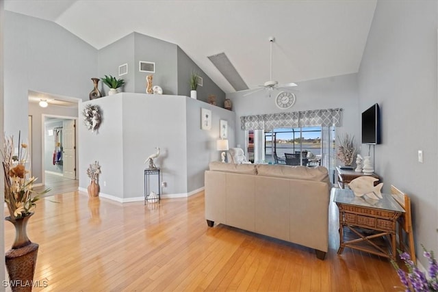 living room with ceiling fan, high vaulted ceiling, and light hardwood / wood-style flooring