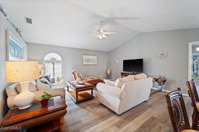 living room featuring ceiling fan, light hardwood / wood-style floors, and lofted ceiling