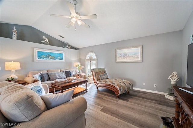 living room with ceiling fan, hardwood / wood-style floors, and vaulted ceiling