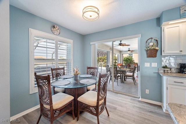 dining room with light hardwood / wood-style flooring, ceiling fan, and a healthy amount of sunlight