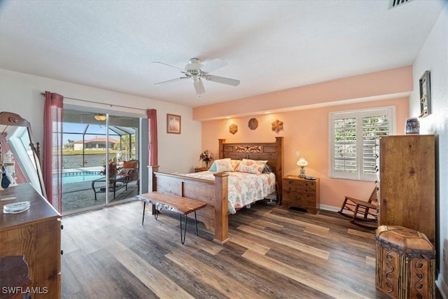 bedroom featuring ceiling fan, dark wood-type flooring, and access to outside