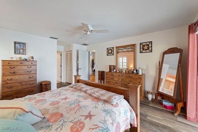 bedroom with hardwood / wood-style floors and ceiling fan