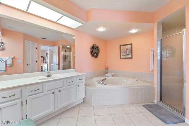 bathroom featuring tile patterned flooring, vanity, and shower with separate bathtub