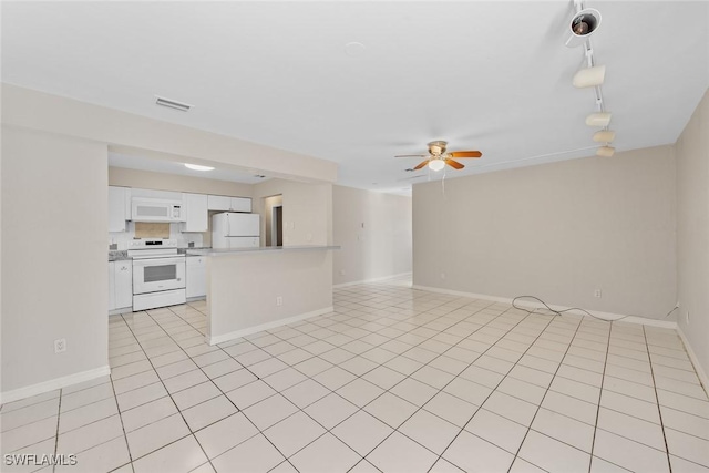 interior space with light tile patterned floors, baseboards, visible vents, and ceiling fan