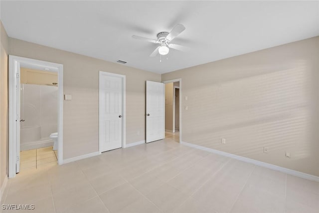 unfurnished bedroom with light tile patterned floors, visible vents, baseboards, and connected bathroom