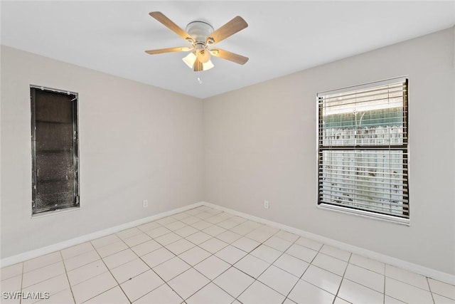 unfurnished room with baseboards and a ceiling fan