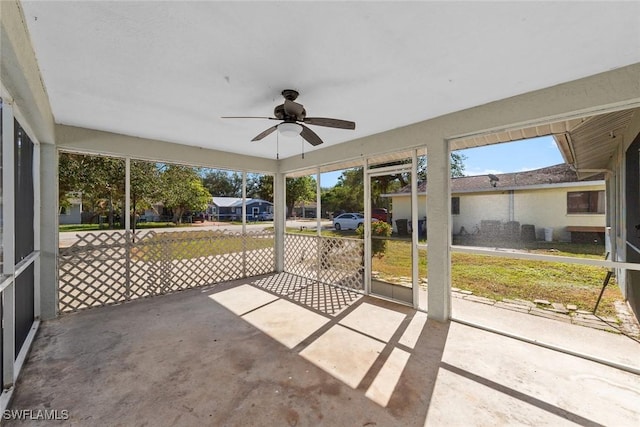 unfurnished sunroom with a ceiling fan