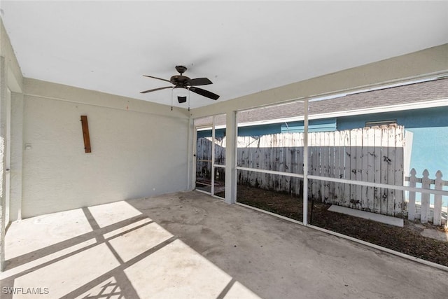 view of patio with a ceiling fan and fence