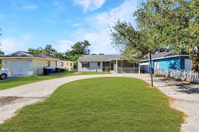 ranch-style house featuring a garage and a front lawn