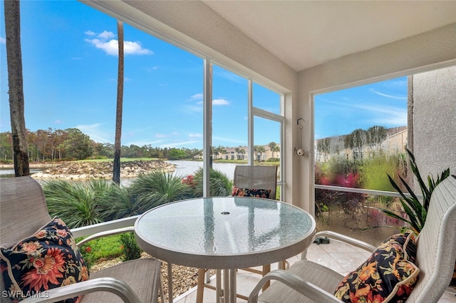 sunroom / solarium with a water view