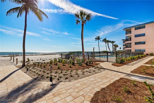 view of community featuring a water view and a swimming pool