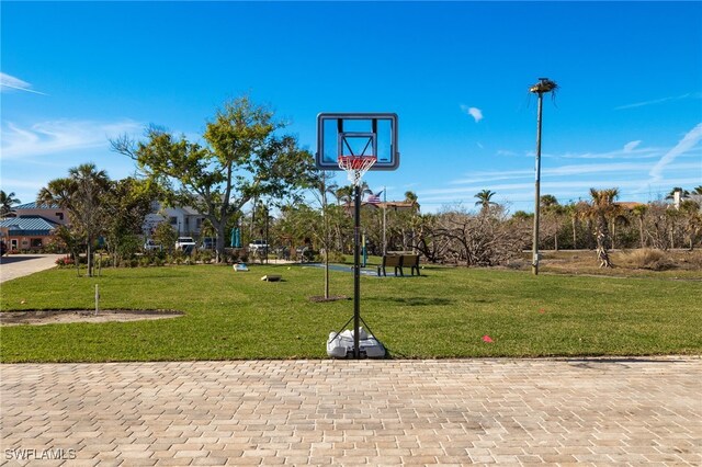 view of basketball court featuring a yard