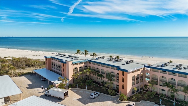 birds eye view of property featuring a view of the beach and a water view