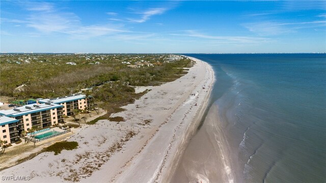 birds eye view of property with a water view and a view of the beach