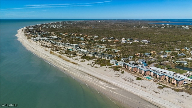 birds eye view of property featuring a water view and a beach view