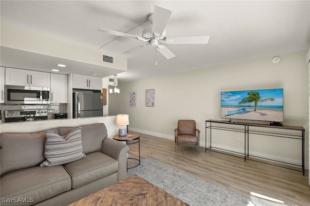 living room featuring ceiling fan and light wood-type flooring