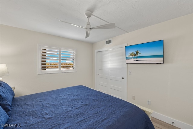 bedroom with hardwood / wood-style flooring and ceiling fan