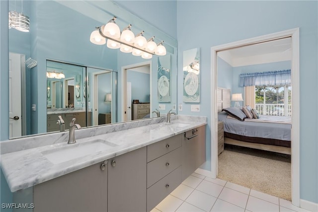 full bathroom with a sink, tile patterned flooring, double vanity, and connected bathroom