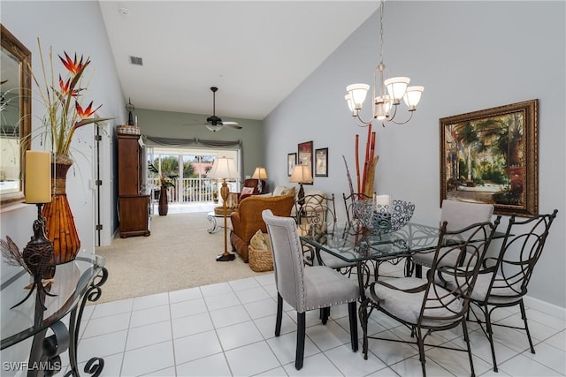 dining room with visible vents, light tile patterned flooring, light carpet, high vaulted ceiling, and ceiling fan with notable chandelier