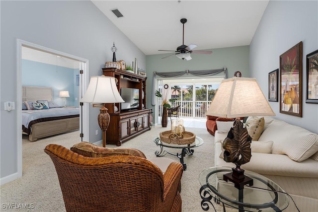 living room with a ceiling fan, visible vents, vaulted ceiling, and light carpet