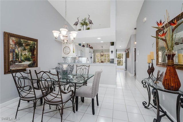 dining space with a chandelier, high vaulted ceiling, and light tile patterned flooring