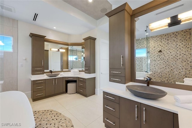 bathroom featuring tile patterned floors, plus walk in shower, plenty of natural light, and vanity