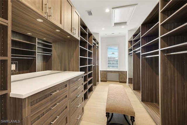 spacious closet with light hardwood / wood-style flooring