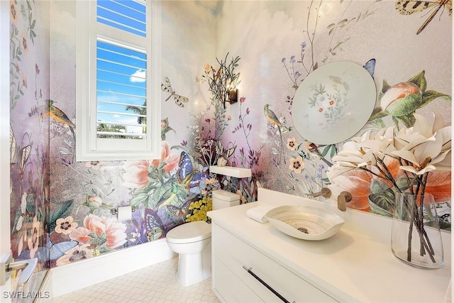 bathroom featuring tile patterned flooring, vanity, and toilet