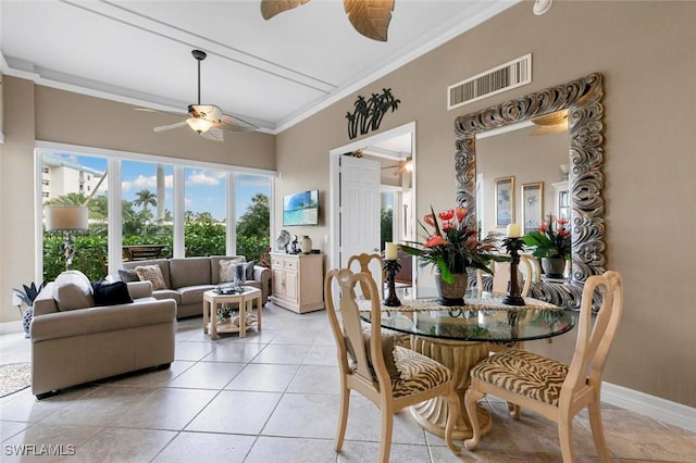 tiled dining room featuring crown molding