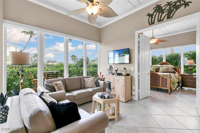 living room with light tile patterned floors, ceiling fan, and crown molding