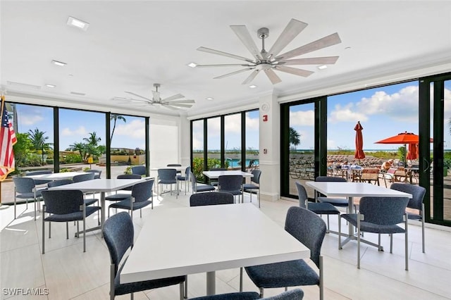 dining room with light tile patterned floors, expansive windows, and ceiling fan