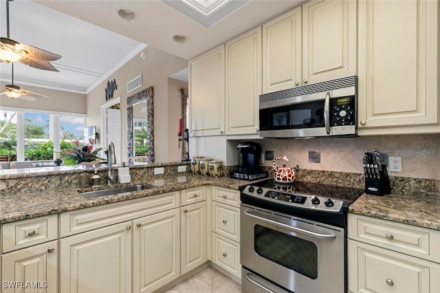 kitchen featuring visible vents, ornamental molding, decorative backsplash, appliances with stainless steel finishes, and a sink