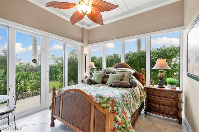 tiled bedroom with access to exterior, ceiling fan, multiple windows, and ornamental molding