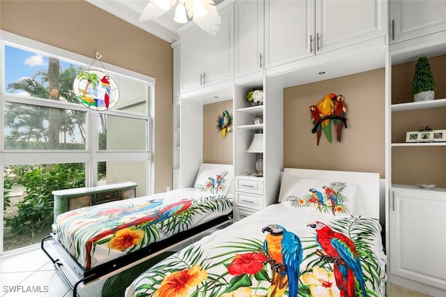 bedroom featuring ceiling fan, light tile patterned flooring, and crown molding