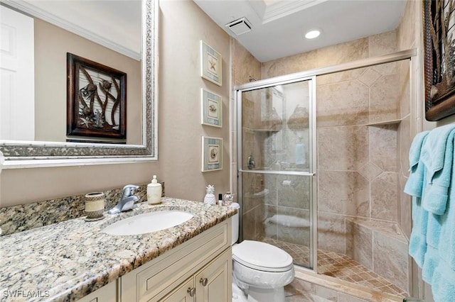 bathroom with vanity, toilet, an enclosed shower, and crown molding