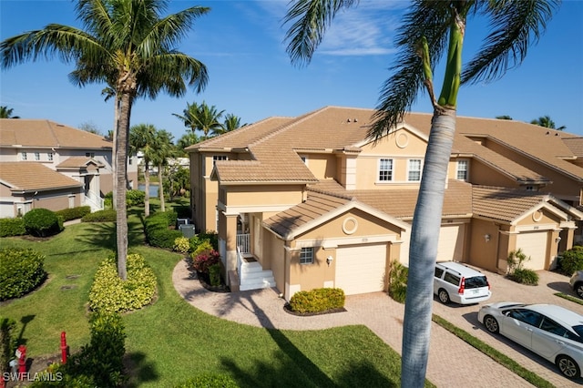 view of front of home with a front yard and a garage