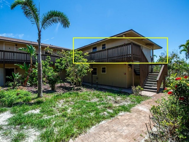 rear view of house with a wooden deck