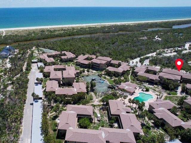 birds eye view of property with a water view and a view of the beach