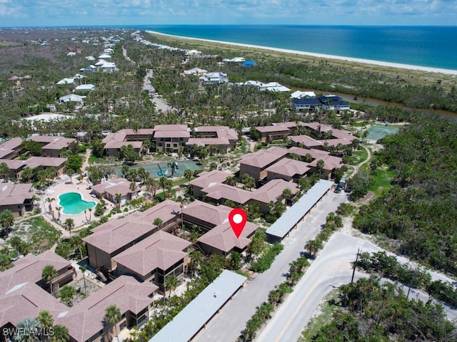 aerial view with a water view and a beach view