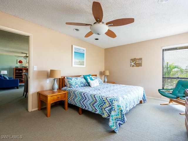 carpeted bedroom with a textured ceiling and ceiling fan