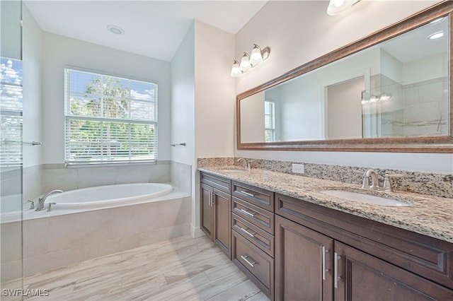 bathroom featuring plus walk in shower and vanity