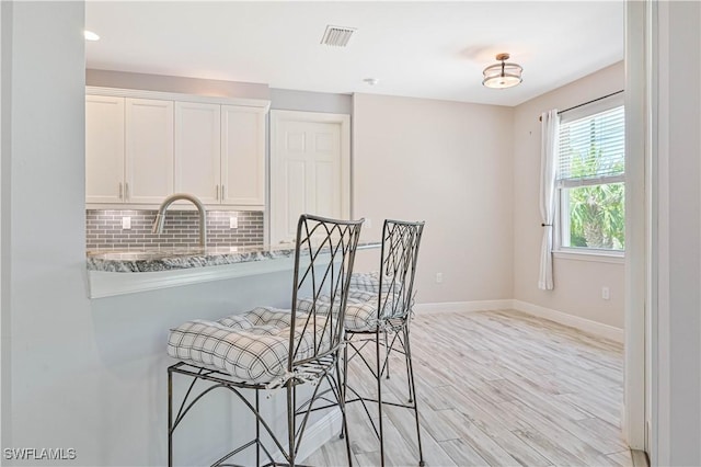 dining area featuring sink and light hardwood / wood-style floors