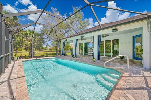 view of swimming pool featuring a lanai, a patio area, and ceiling fan