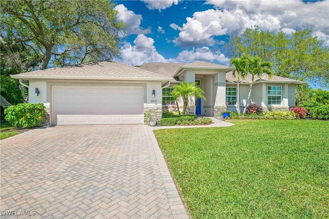 view of front of property with a front lawn and a garage